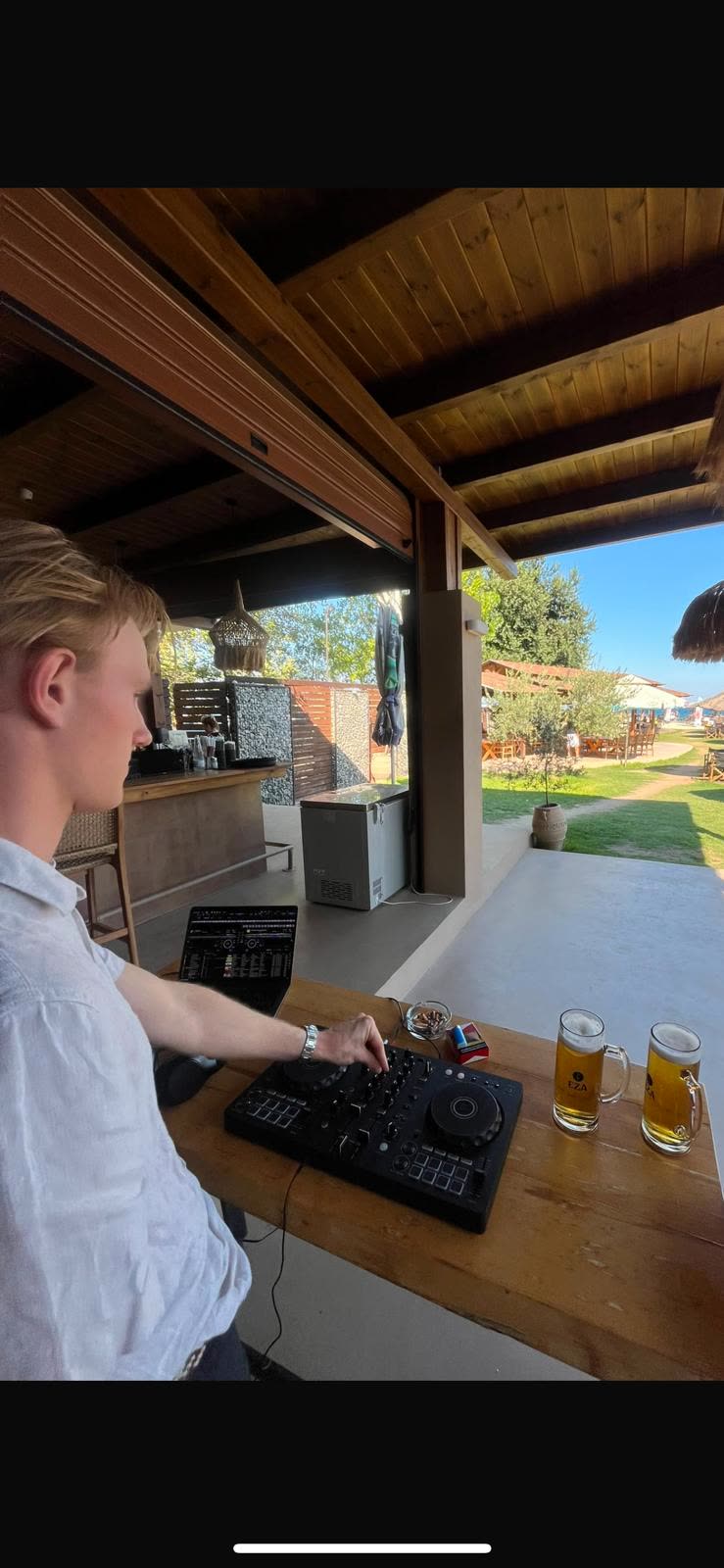Hendrik Wulf DJing at an outdoor beach club bar